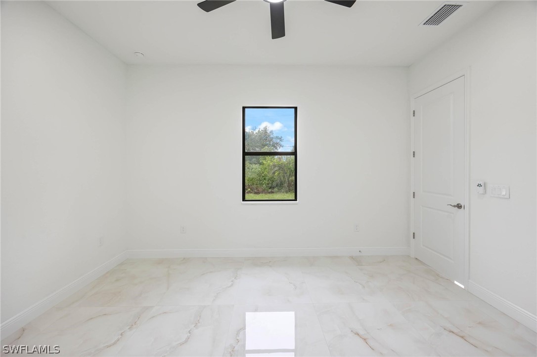 2909 37th Street Southwest Lehigh Acres, FL 33976 - Photo 18 of 29 an empty room with windows