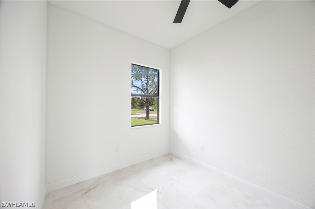 2909 37th Street Southwest Lehigh Acres, FL 33976 - Photo 20 of 29 a view of an empty room with a window