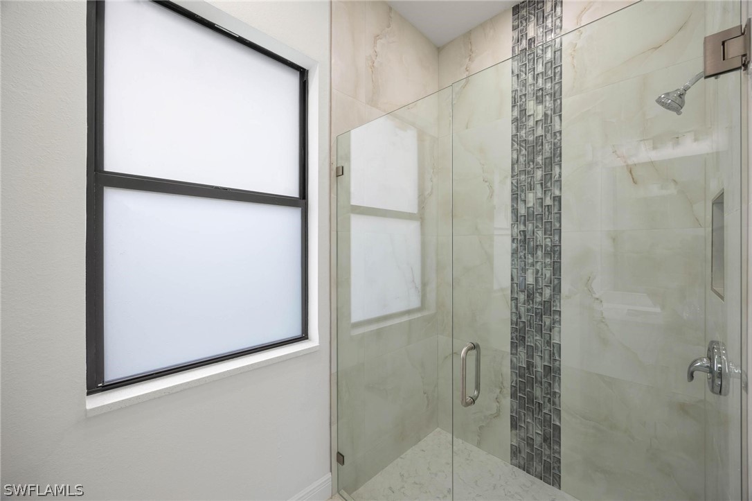 2909 37th Street Southwest Lehigh Acres, FL 33976 - Photo 22 of 29 a bathroom with a shower