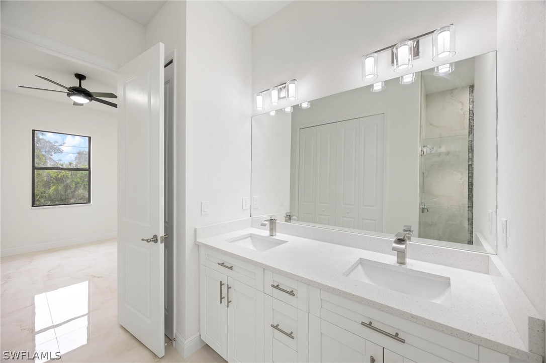 2909 37th Street Southwest Lehigh Acres, FL 33976 - Photo 23 of 29 a bathroom with a double vanity sink and a mirror