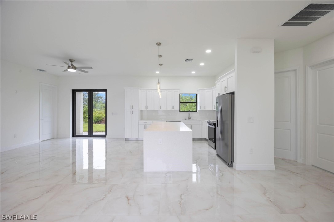 2909 37th Street Southwest Lehigh Acres, FL 33976 - Photo 26 of 29 a view of a kitchen with a refrigerator a sink and dishwasher