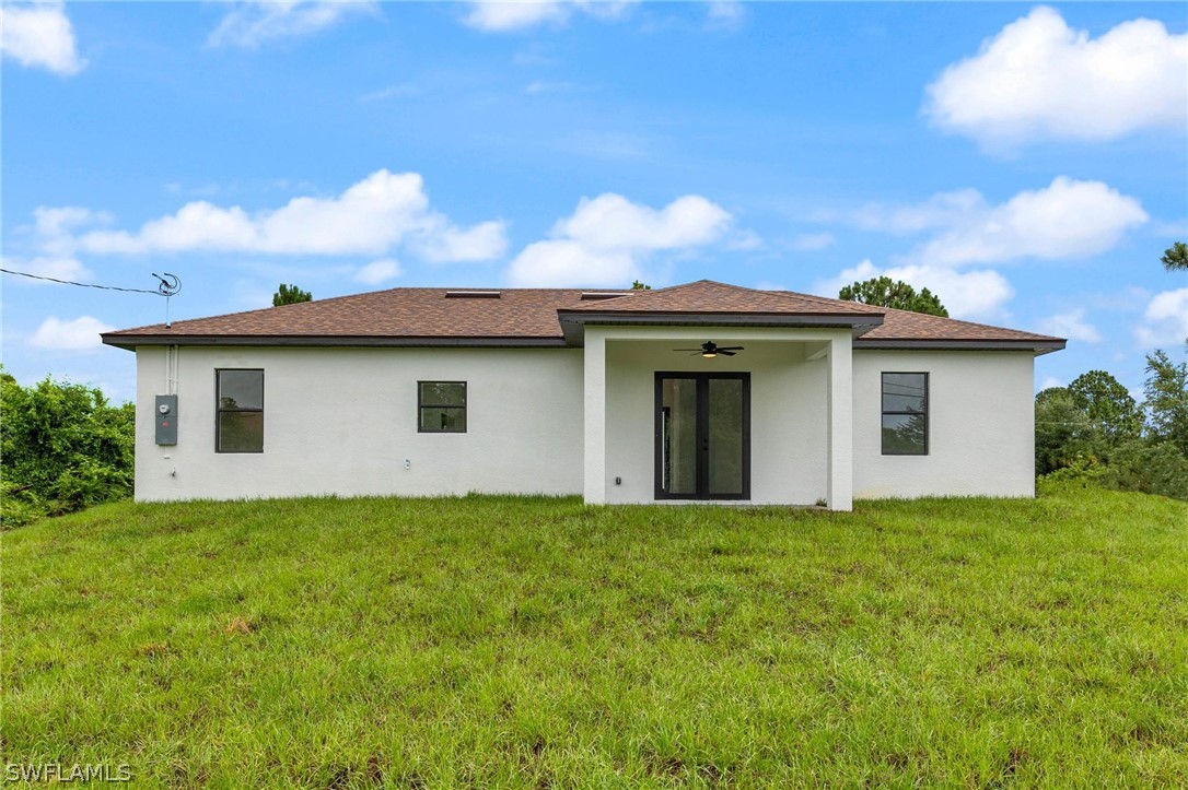 2909 37th Street Southwest Lehigh Acres, FL 33976 - Photo 27 of 29 a view of a house with a yard