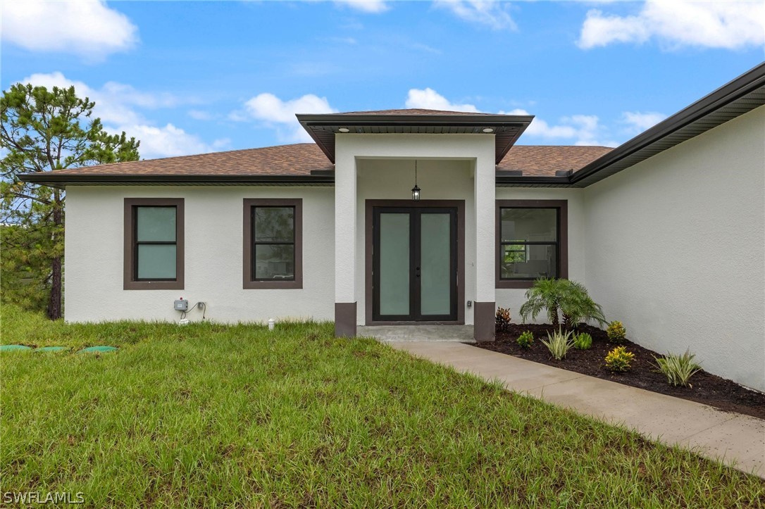 2909 37th Street Southwest Lehigh Acres, FL 33976 - Photo 3 of 29 a house view with a garden space