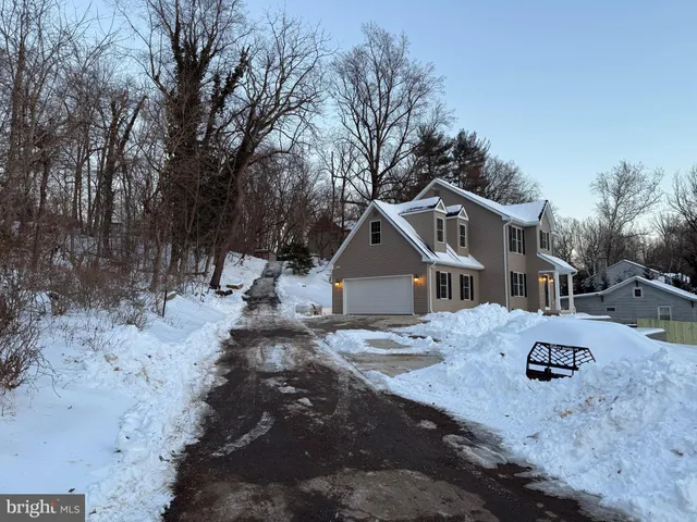 a view of a house with a yard covered in snow