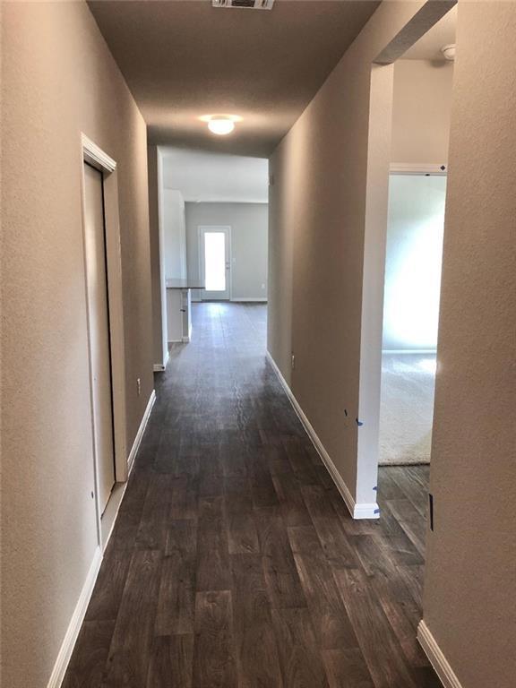 10801 Defender Trail Austin, TX 78754 - Photo 3 of 11 a view of a hallway with wooden floor