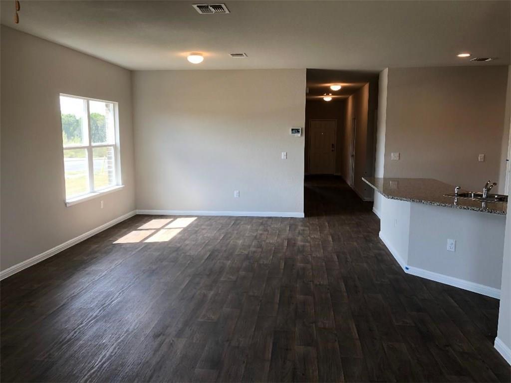 10801 Defender Trail Austin, TX 78754 - Photo 4 of 11 an empty room with wooden floor and windows