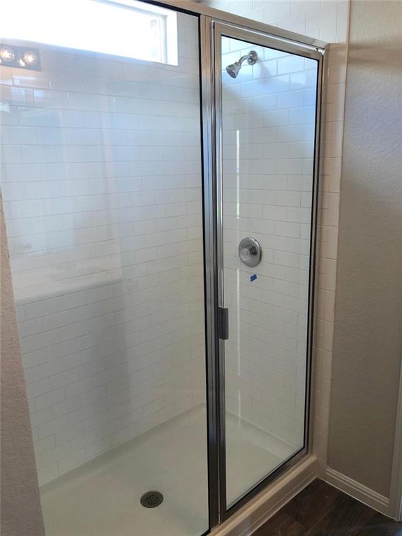 10801 Defender Trail Austin, TX 78754 - Photo 9 of 11 a bathroom with a glass shower door