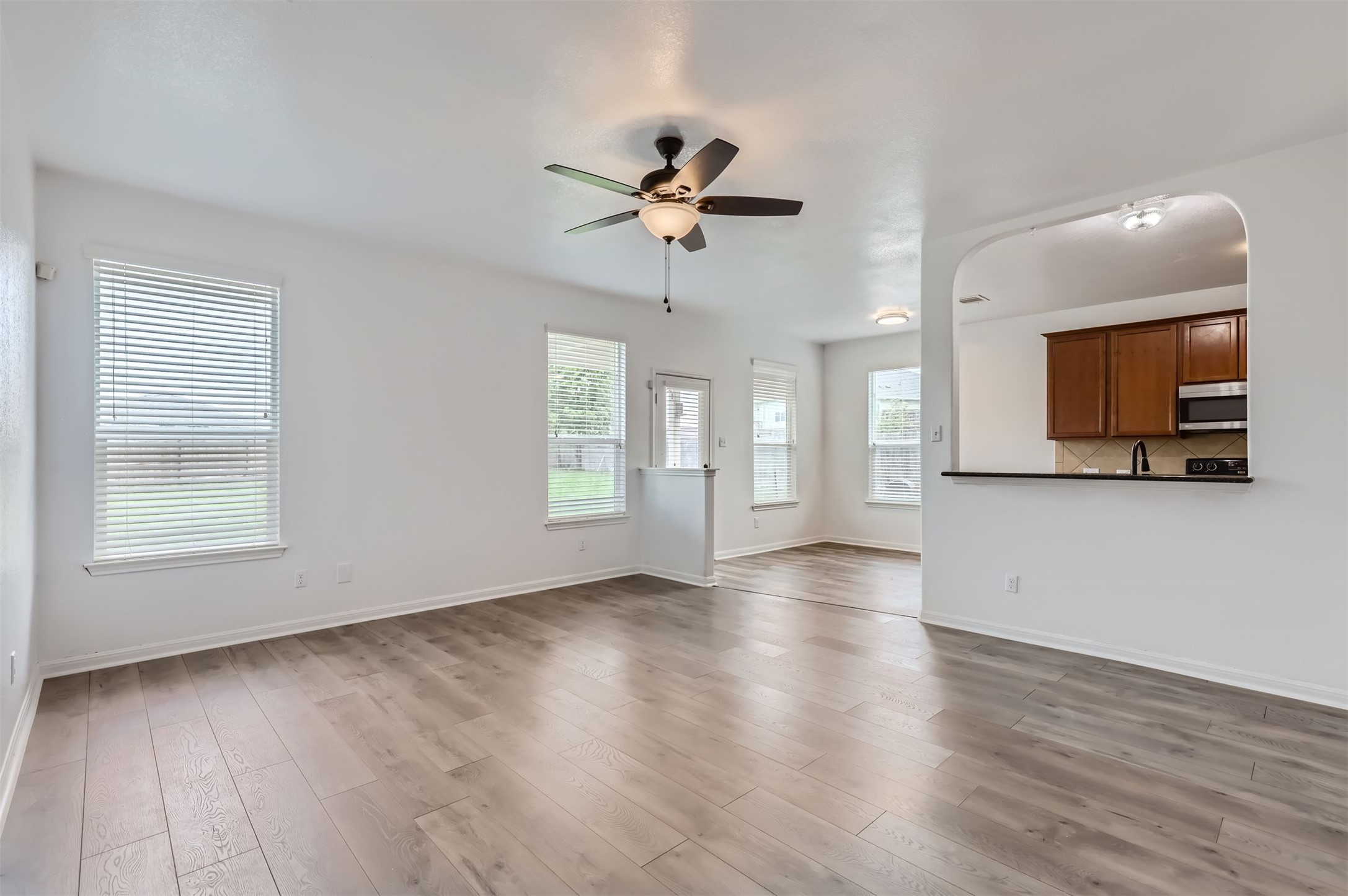 131 Lavaca Loop Hutto, TX 78634 - Photo 29 of 29 An open floor plan with neutral flooring connects a comfortable living area to a practical kitchen space.