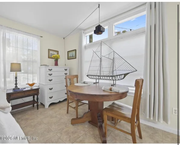 a view of a livingroom with furniture and a window
