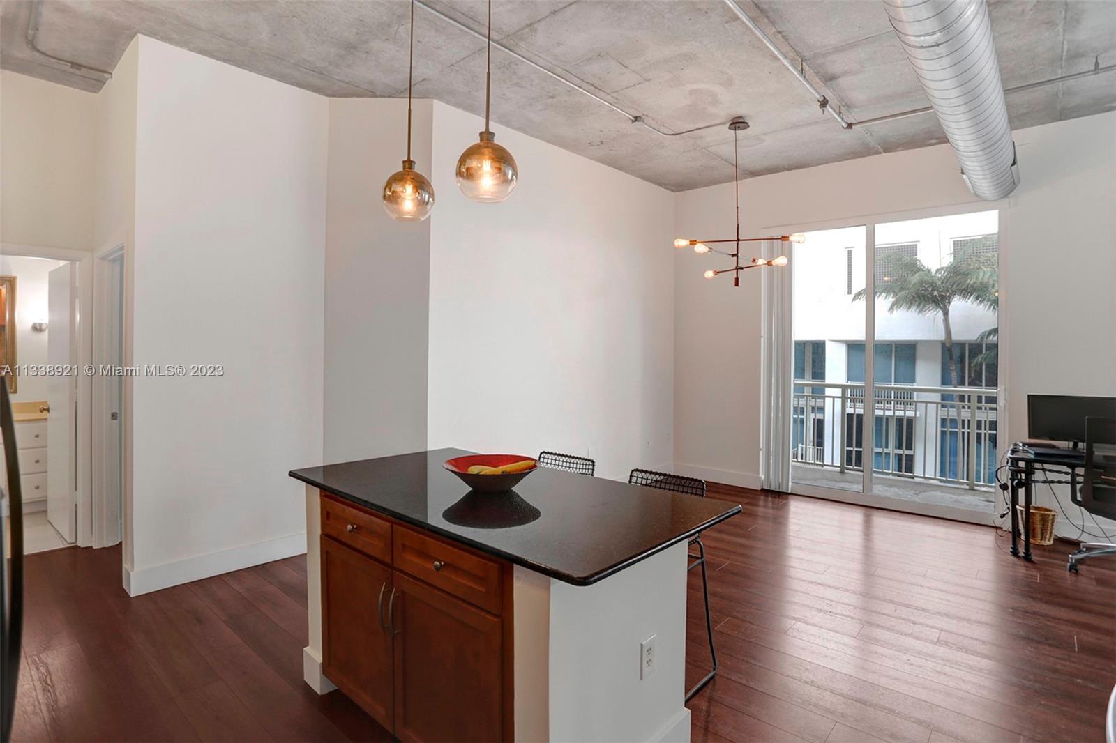 2001 Biscayne Boulevard, Unit 2202 Miami, FL 33137 - Photo 11 of 31 a kitchen with stainless steel appliances granite countertop a sink and wooden floor