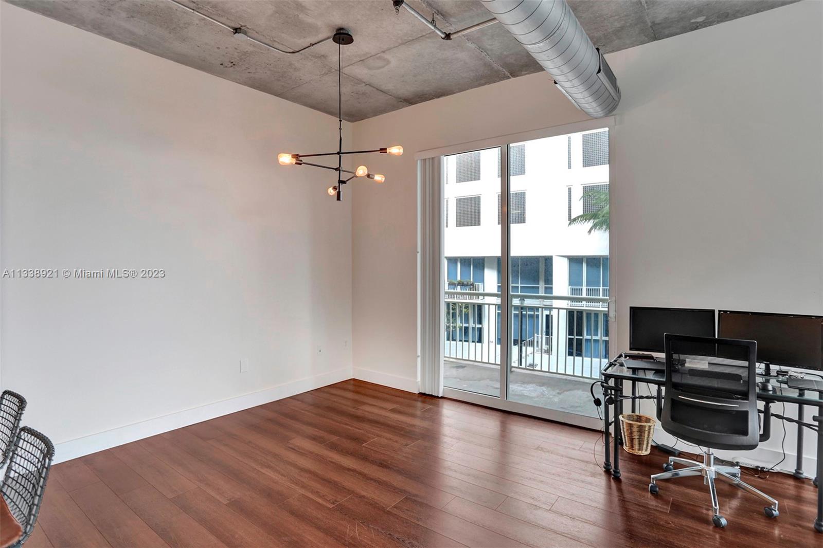 2001 Biscayne Boulevard, Unit 2202 Miami, FL 33137 - Photo 12 of 31 a view of a workspace with wooden floor and a window