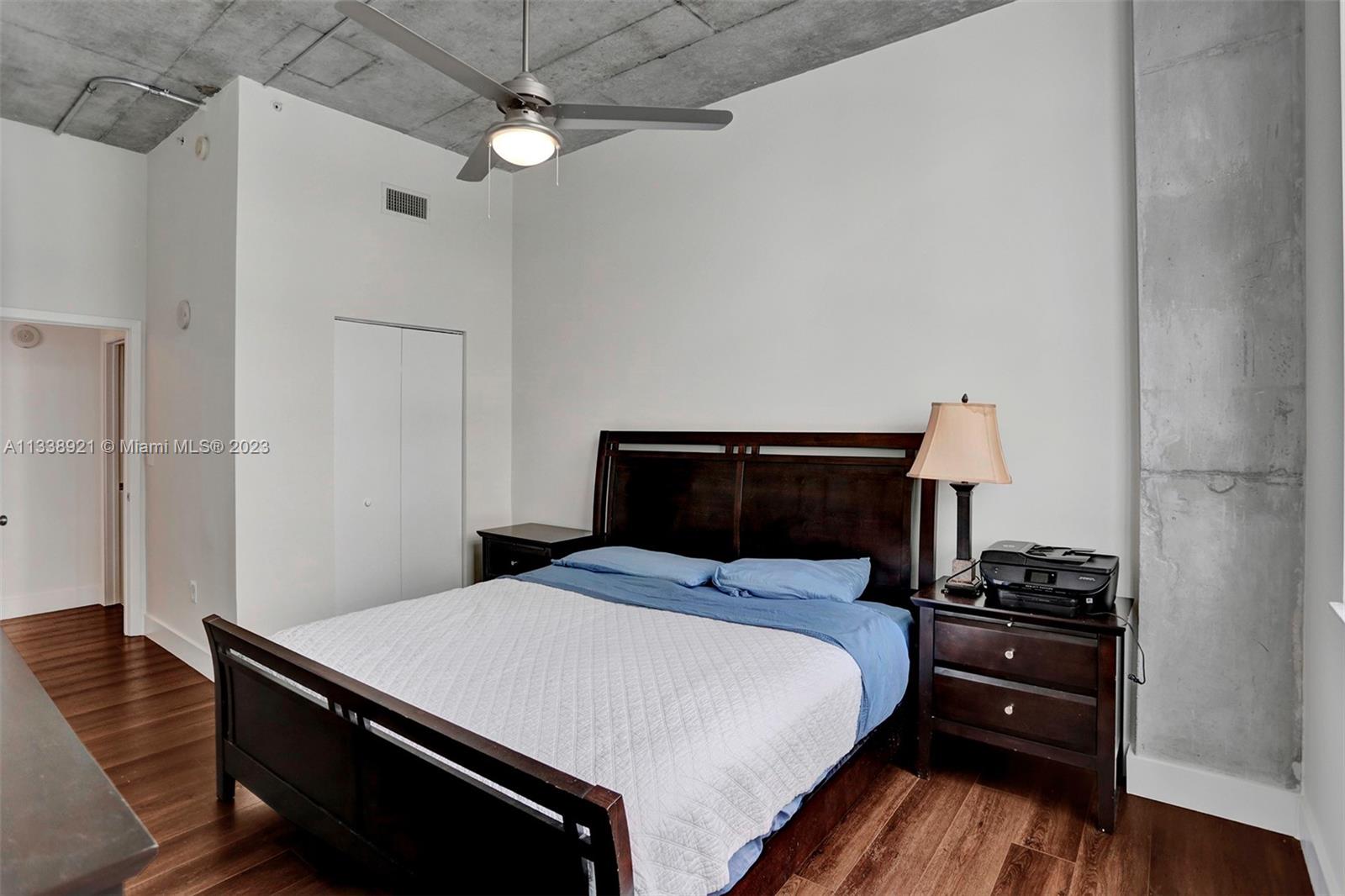 2001 Biscayne Boulevard, Unit 2202 Miami, FL 33137 - Photo 14 of 31 a bedroom with a bed and a chandelier