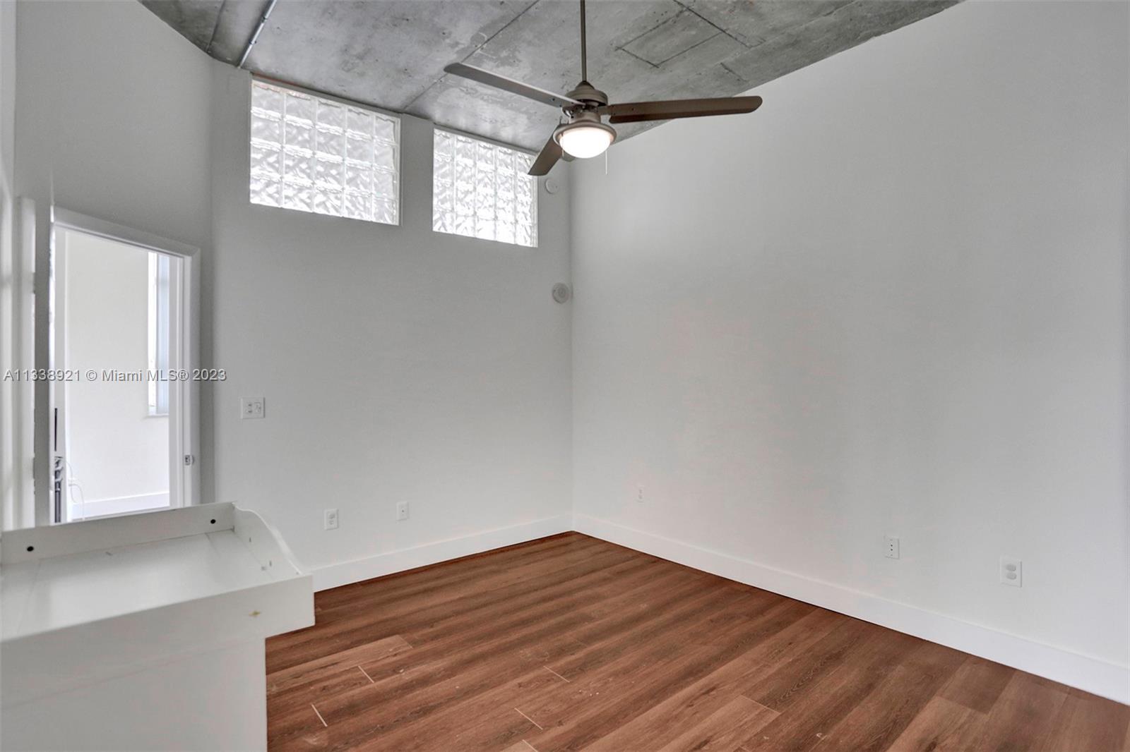 2001 Biscayne Boulevard, Unit 2202 Miami, FL 33137 - Photo 15 of 31 a view of empty room with wooden floor and fan