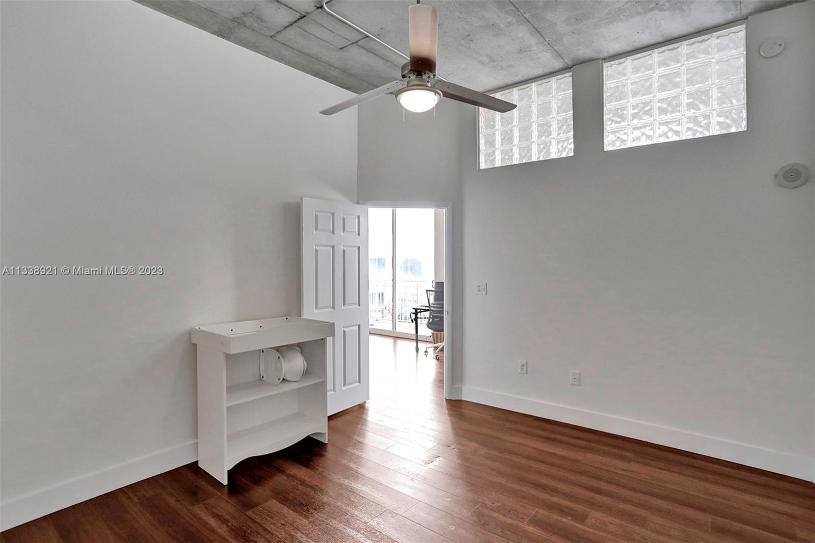 2001 Biscayne Boulevard, Unit 2202 Miami, FL 33137 - Photo 16 of 31 a view of an empty room with wooden floor and a window