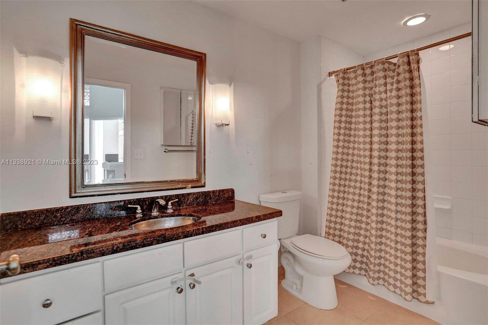 2001 Biscayne Boulevard, Unit 2202 Miami, FL 33137 - Photo 18 of 31 a bathroom with a granite countertop sink toilet and shower