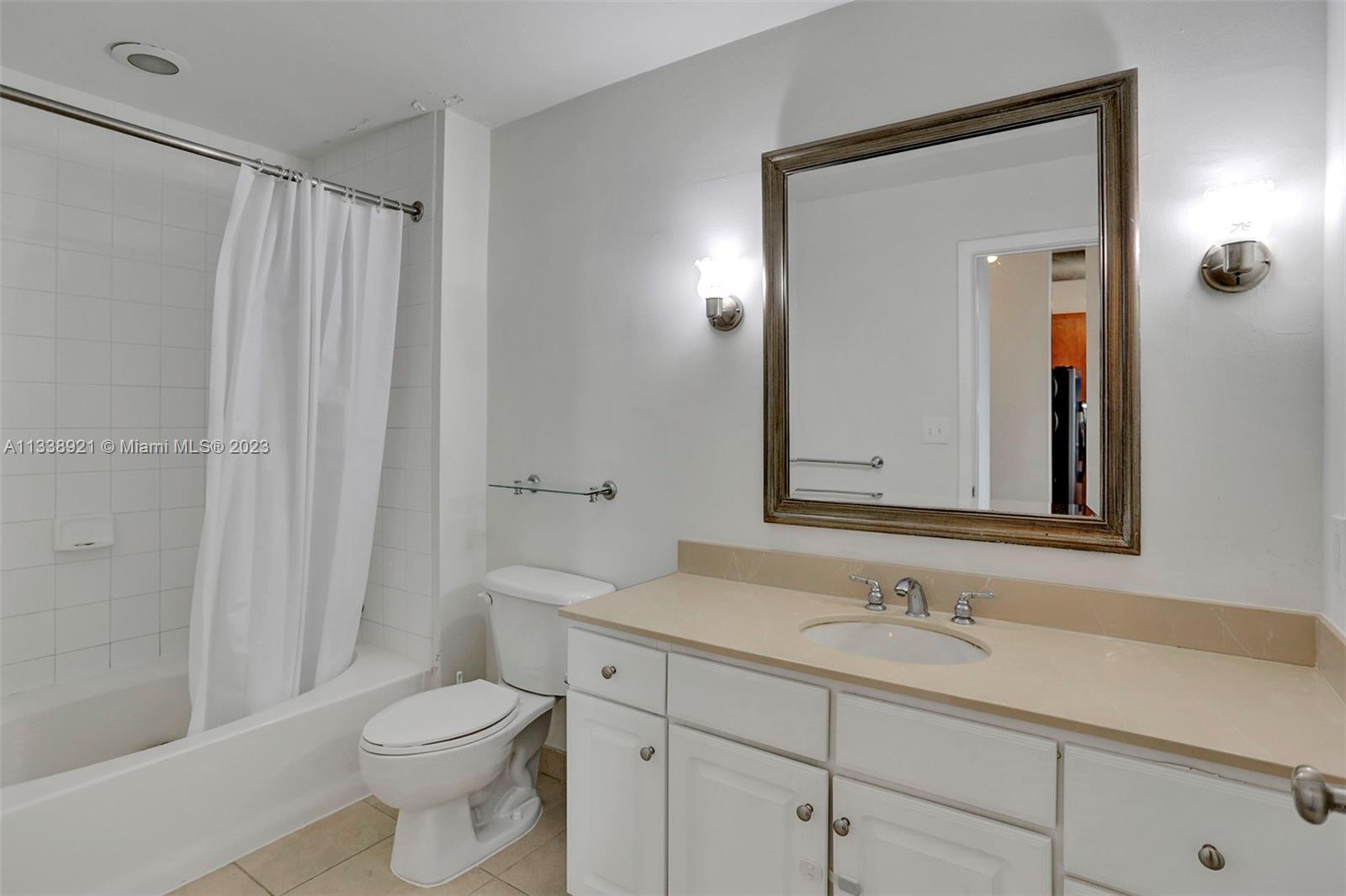 2001 Biscayne Boulevard, Unit 2202 Miami, FL 33137 - Photo 19 of 31 a bathroom with a sink a toilet and shower