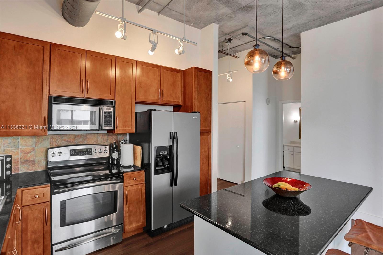 2001 Biscayne Boulevard, Unit 2202 Miami, FL 33137 - Photo 6 of 31 a kitchen with stainless steel appliances a refrigerator and a stove