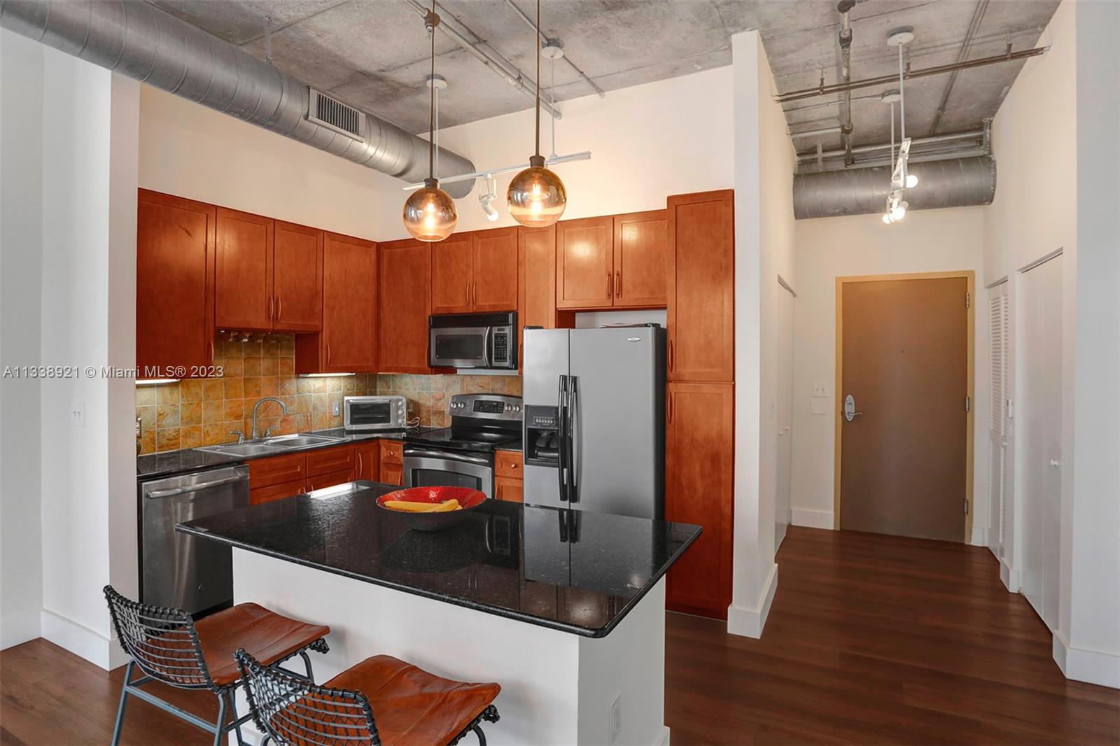 2001 Biscayne Boulevard, Unit 2202 Miami, FL 33137 - Photo 7 of 31 a kitchen with stainless steel appliances granite countertop a refrigerator a stove and a wooden floors