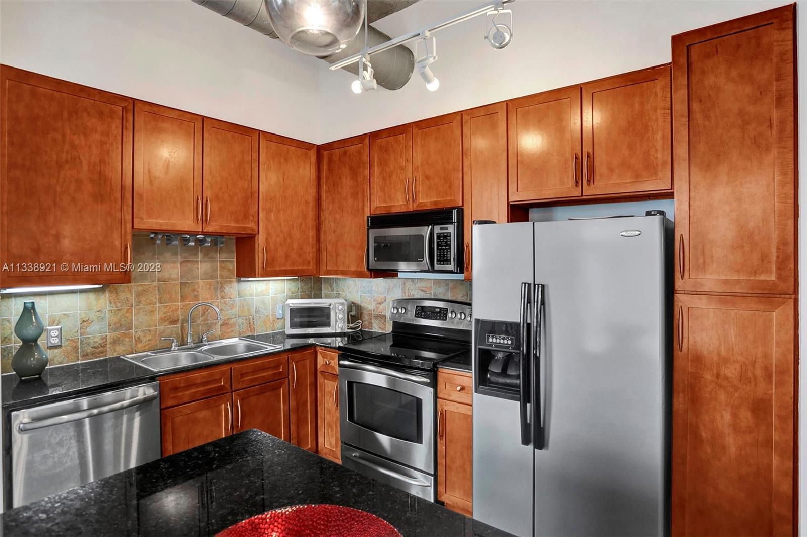 2001 Biscayne Boulevard, Unit 2202 Miami, FL 33137 - Photo 8 of 31 a kitchen with stainless steel appliances granite countertop a refrigerator stove microwave sink and cabinets