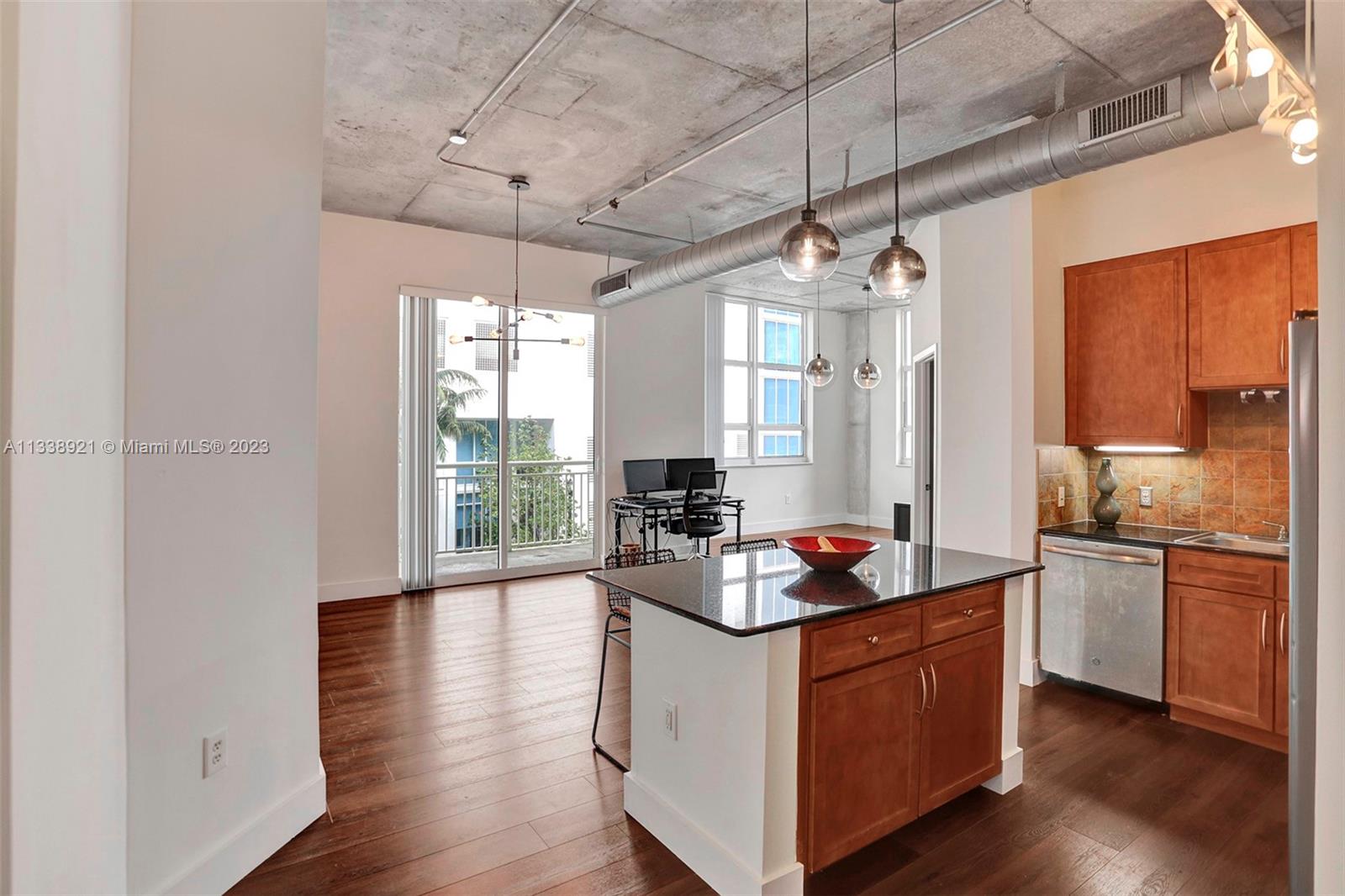 2001 Biscayne Boulevard, Unit 2202 Miami, FL 33137 - Photo 10 of 31 a kitchen with stainless steel appliances granite countertop a stove a sink dishwasher a refrigerator and white cabinets with wooden floor