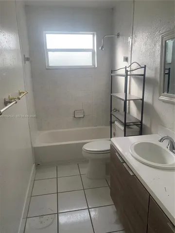 a view of empty room with wooden floor and closet