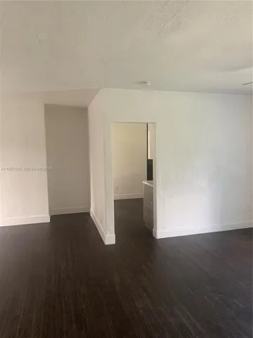 a view of a room with wooden floor