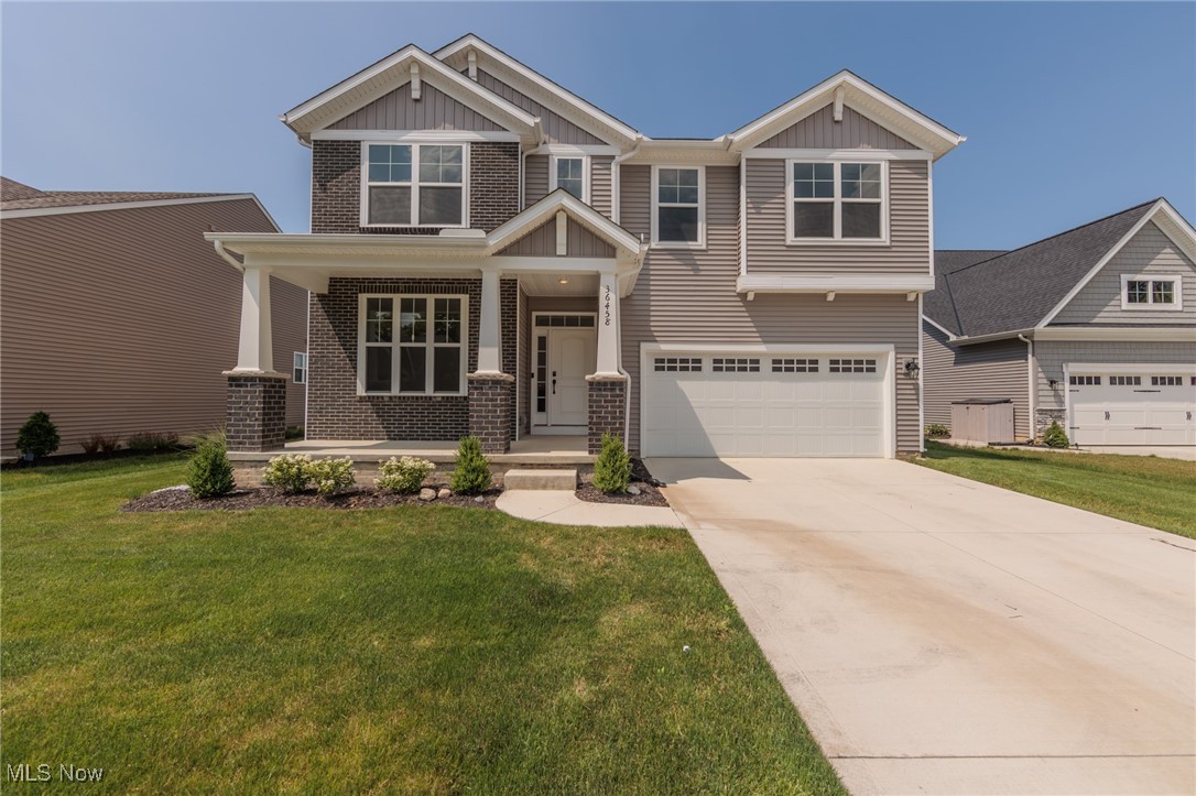 36458 Appian Way North Ridgeville, OH 44039 - Photo 1 of 37 Craftsman inspired home with a garage, a porch, and a front lawn