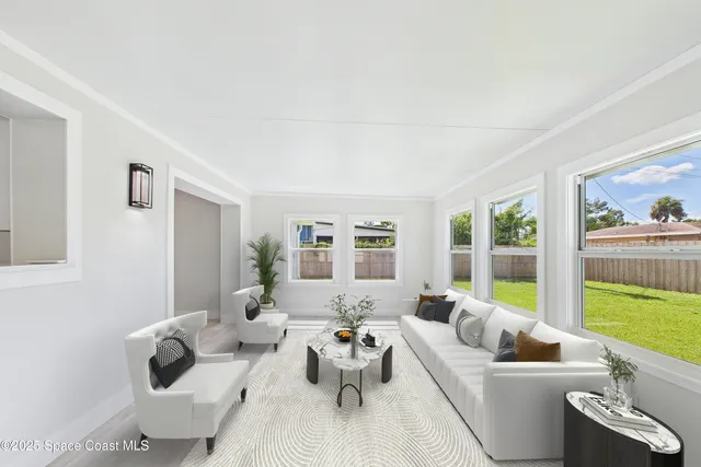 a living room with furniture and a large window with outer view