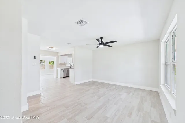 a view of a kitchen with wooden floor and a kitchen