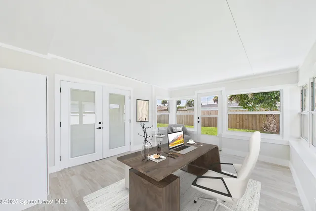 a living room with furniture a flat screen tv and a table