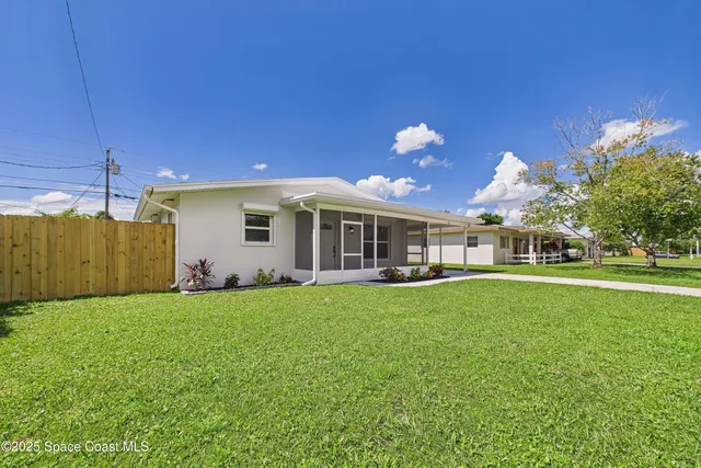 a front view of a house with patio garden and outdoor seating