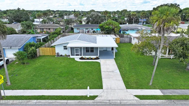 a view of a patio with couches table and chairs with plants and garden