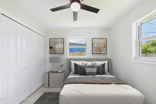 a bedroom with a bed and wooden floor