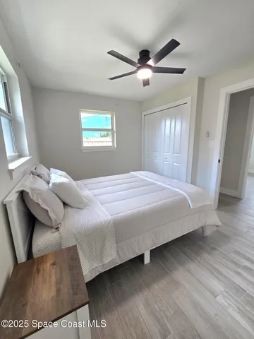 a bedroom with a large bed and a window