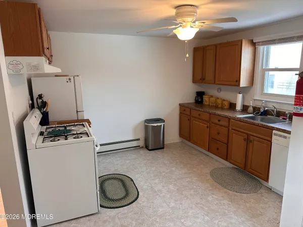 a kitchen with refrigerator a stove a sink and a microwave