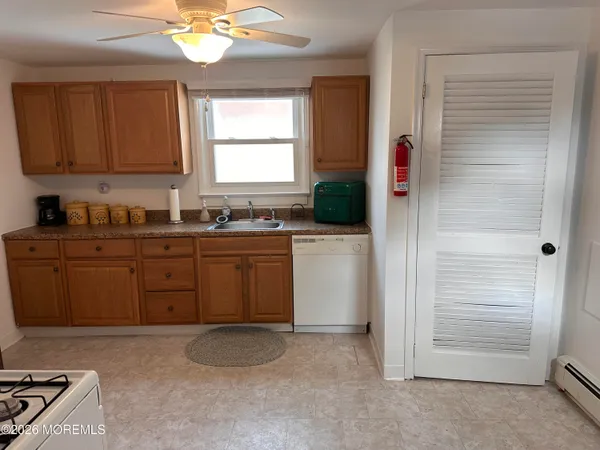 a kitchen with a sink cabinets and window