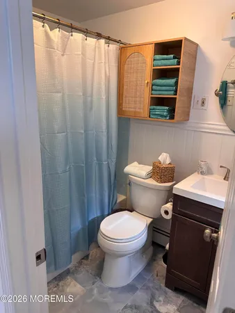 a bathroom with a toilet a sink and a mirror