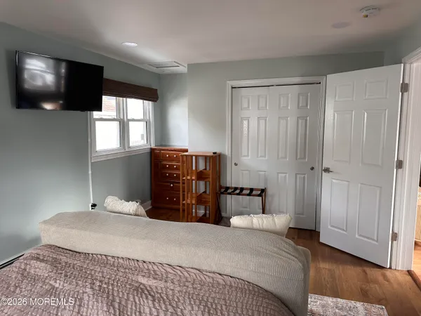 a bedroom with a bed window and television