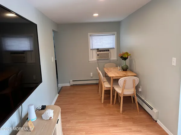 a dining room with furniture and wooden floor