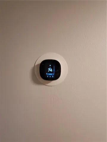 a bedroom with a bed and a television