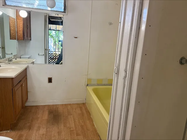 a bathroom with a sink a mirror and a bathtub