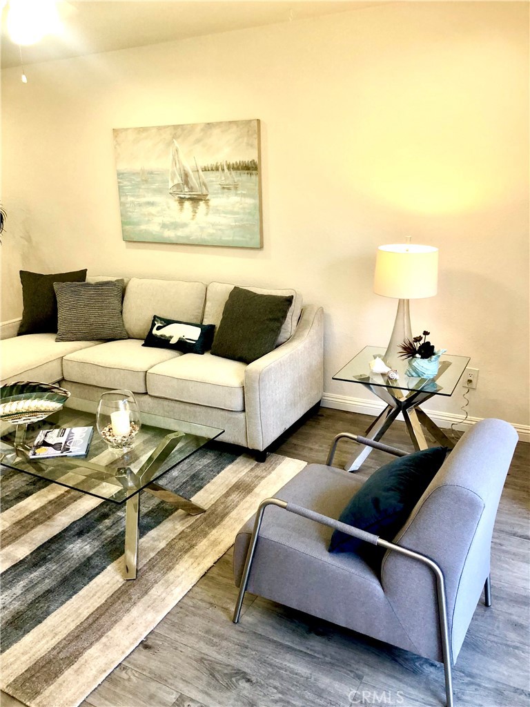 24339 Pasto Road, Unit A Dana Point, CA 92629 - Photo 11 of 28 a living room with furniture and a lamp