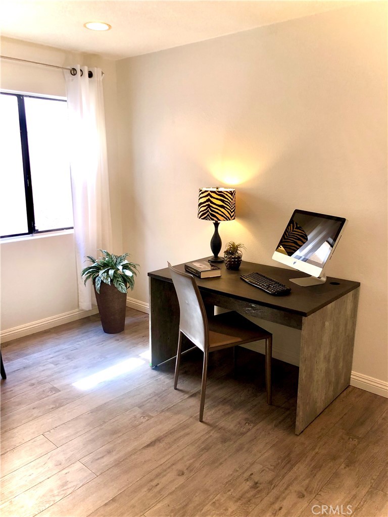 24339 Pasto Road, Unit A Dana Point, CA 92629 - Photo 13 of 28 a view of a workspace with furniture and wooden floor
