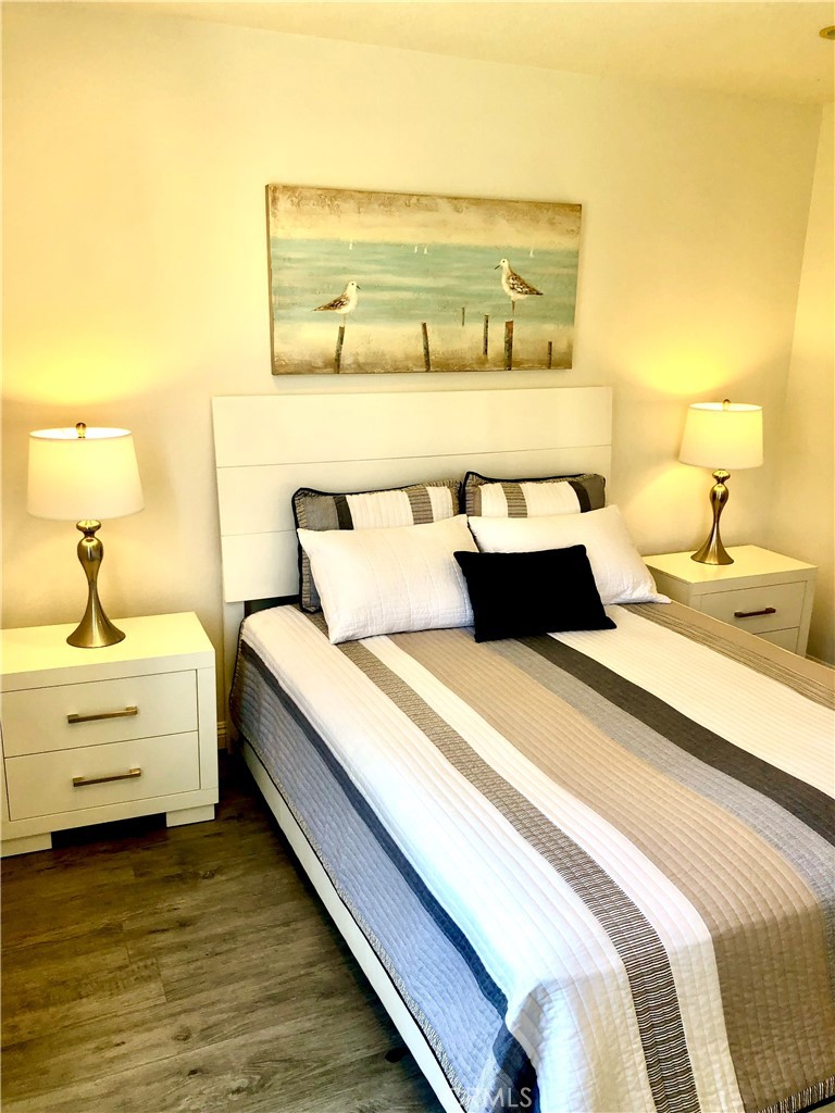24339 Pasto Road, Unit A Dana Point, CA 92629 - Photo 17 of 28 a bedroom with a bed and a night stand