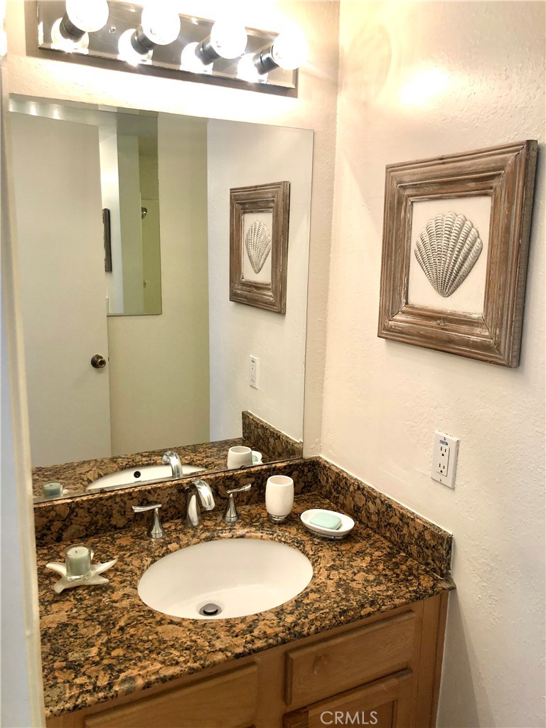24339 Pasto Road, Unit A Dana Point, CA 92629 - Photo 21 of 28 a bathroom with a granite countertop sink