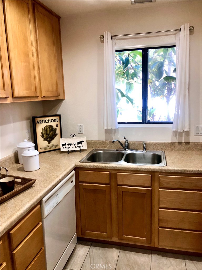 24339 Pasto Road, Unit A Dana Point, CA 92629 - Photo 5 of 28 a kitchen with a sink cabinets and window