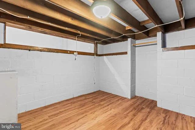 a view of a room with wooden floor