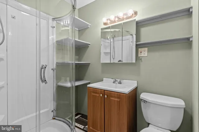 a bathroom with a toilet sink and shower