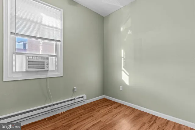 a view of a room with wooden floor and windows