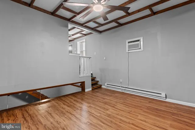 a view of empty room with wooden floor